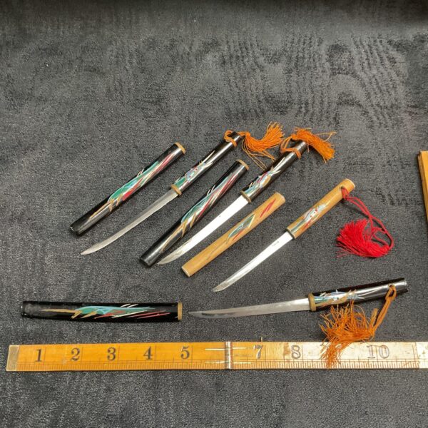 Set of four vintage Japanese paper knives with decorative handles.
