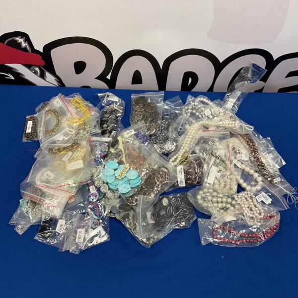 Assorted jewellery making beads in tubs, including pearls and agate.