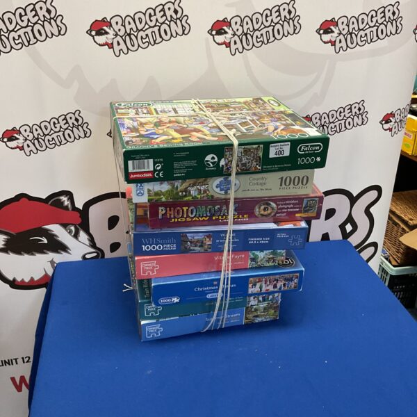 Lot of eight 1000 piece jigsaw puzzles from various brands.