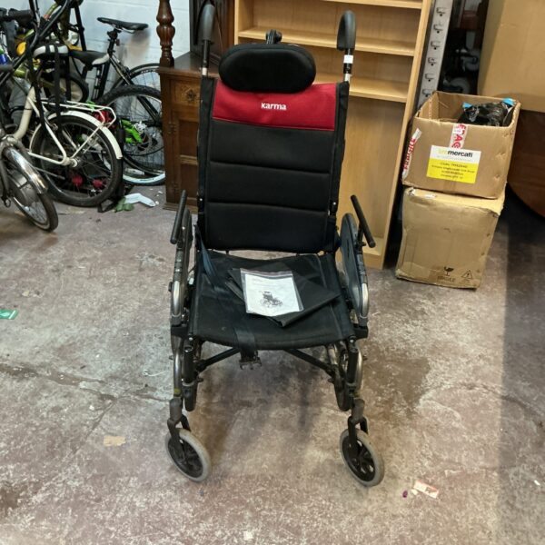 Grey and red Karma folding wheelchair, mobility aid.