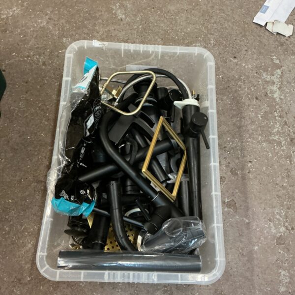 Black kitchen and bathroom taps with accessories in a plastic container.