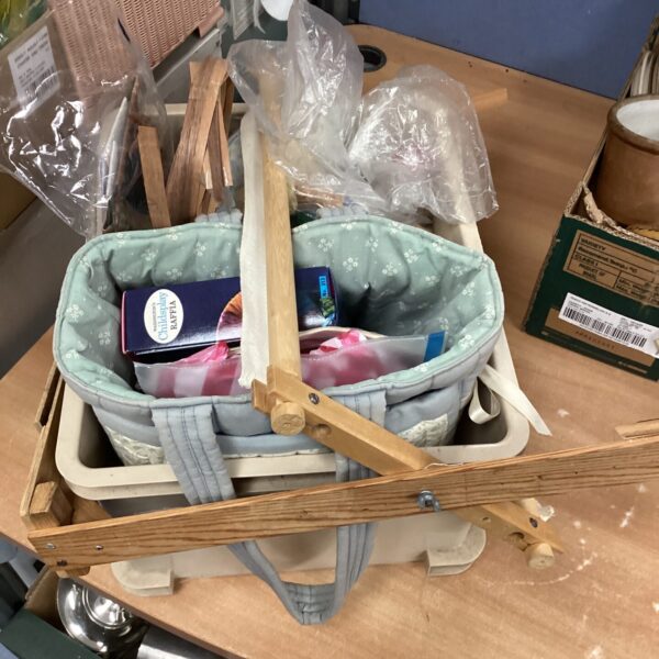 Knitting craft lot with yarn and wooden stand.