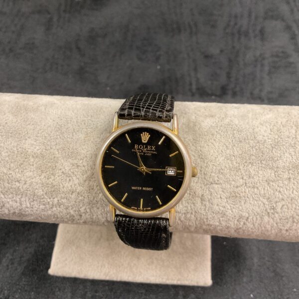 Ladies quartz wristwatch with a black strap and simple dial.