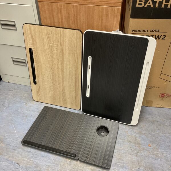 Set of three portable laptop bed tables for comfortable use.