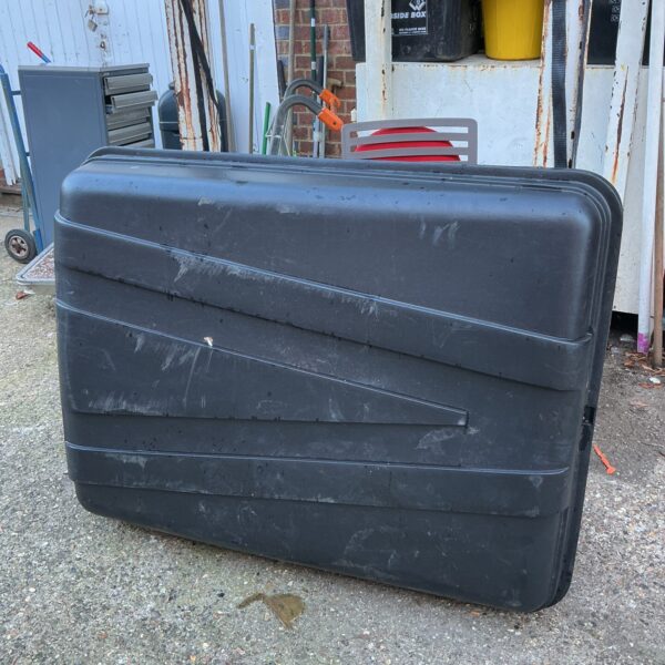 Large dark car roof box for luggage and travel storage.