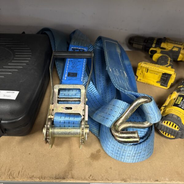Close-up of a large, heavy-duty ratchet strap with a metal mechanism.