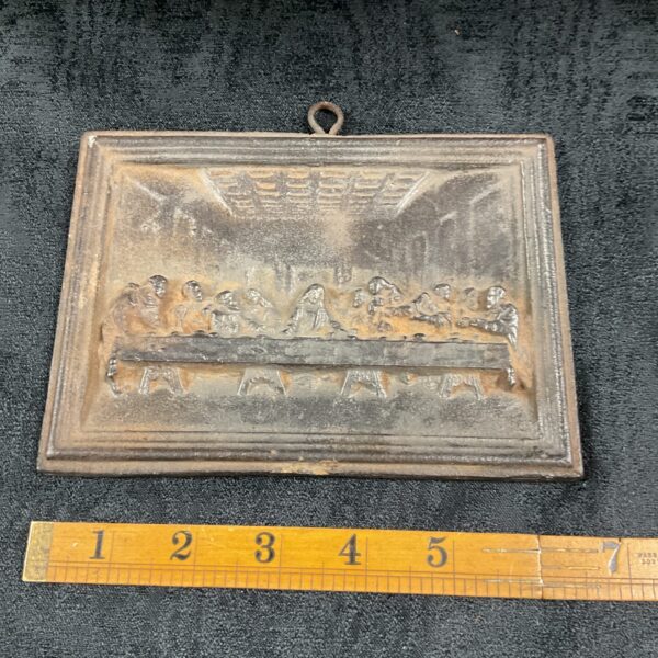 Vintage cast iron Last Supper plaque with detailed relief.