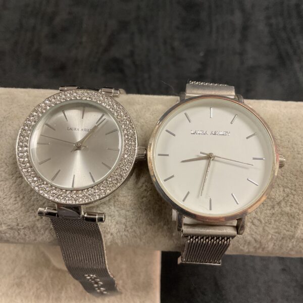 Pair of silver-tone Laura Ashley wristwatches with crystal details.