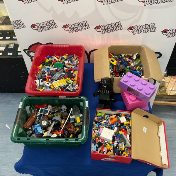 Mixed Lego bricks and Darth Vader figure in a toy lot.