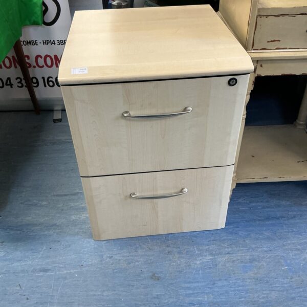 Light oak two-drawer filing cabinet for office document storage.