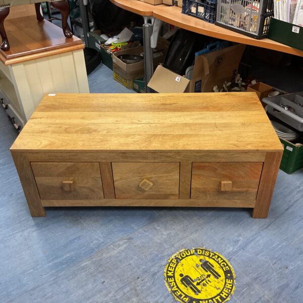 Light oak six-drawer coffee table with rustic design.