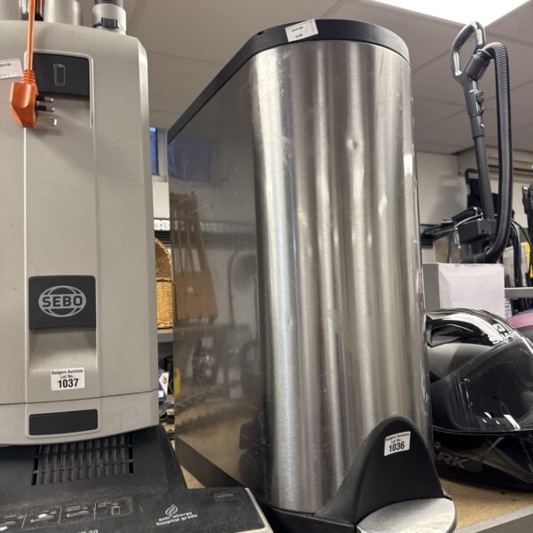 Long stainless steel kitchen pedal bin for kitchen waste disposal.