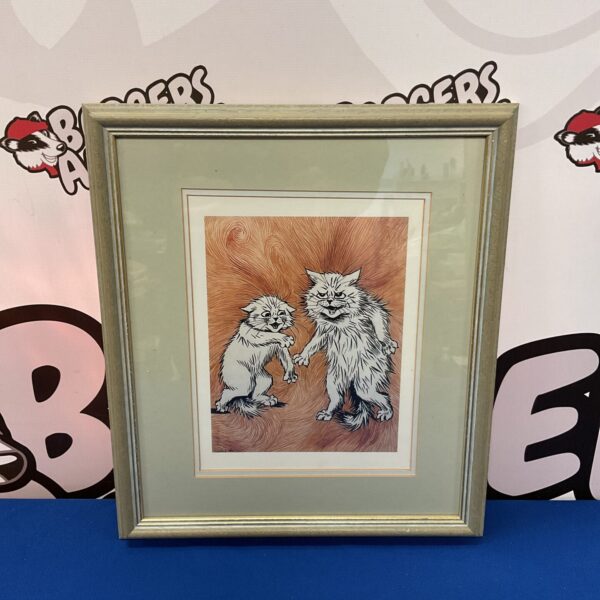 Framed Louis Wain cat print featuring fighting cats.