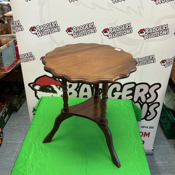 Vintage mahogany occasional table with pie crust top and tripod legs.