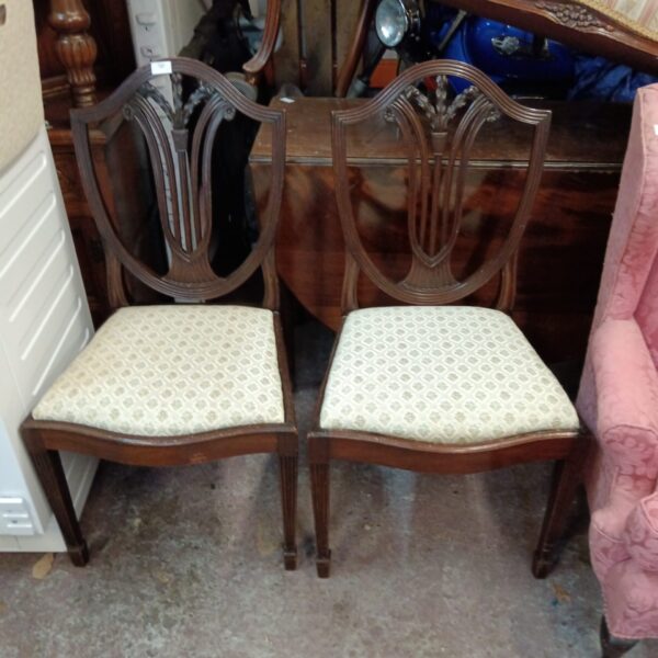Pair of vintage mahogany shield back dining chairs.