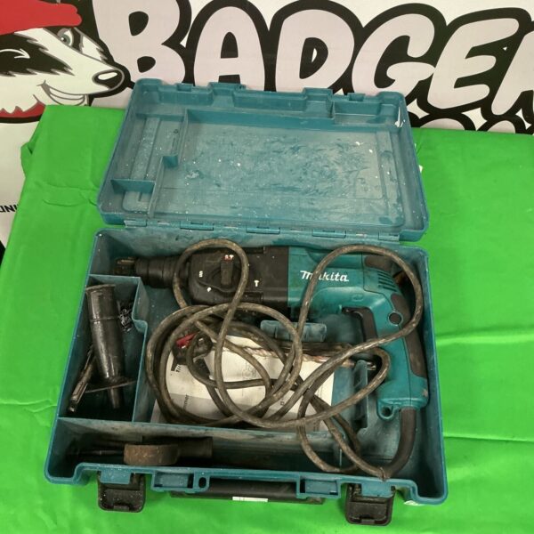 Open Makita hammer drill case showing the drill and accessories inside.
