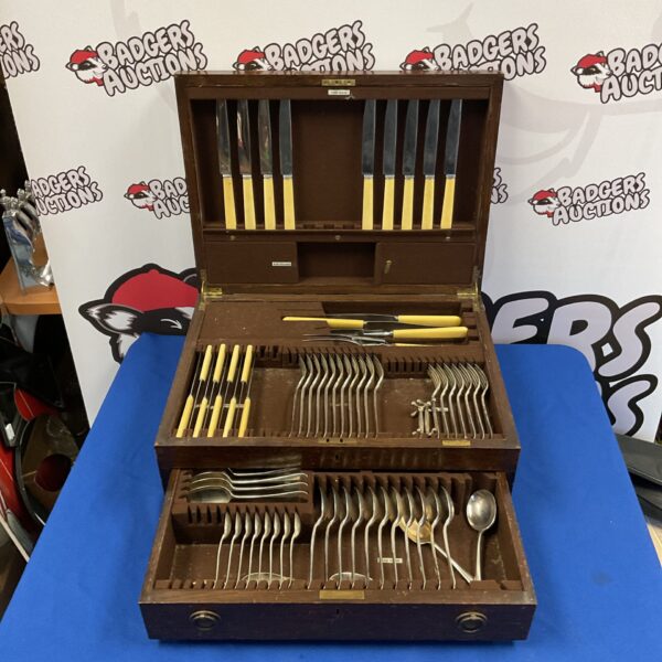 Open oak case displaying a large vintage Mappin & Webb cutlery set.