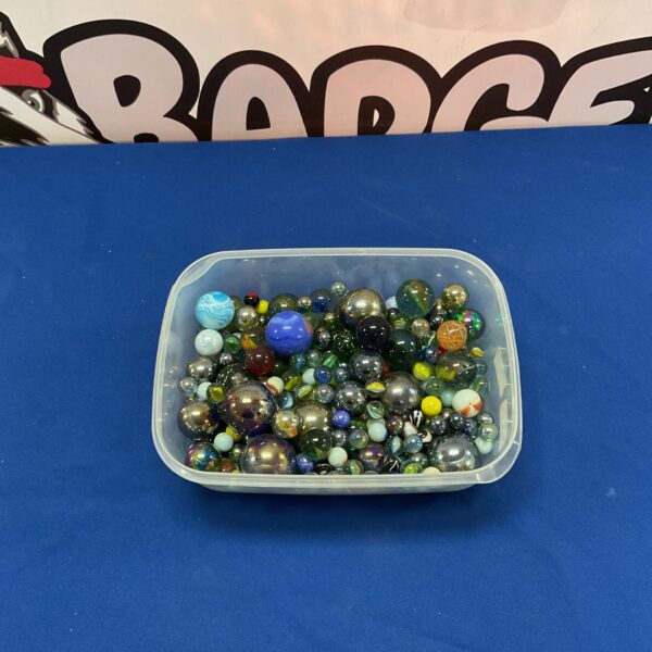 Colourful assortment of glass marbles in a plastic tub.