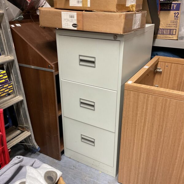 Vintage three-drawer metal filing cabinet for office document storage.