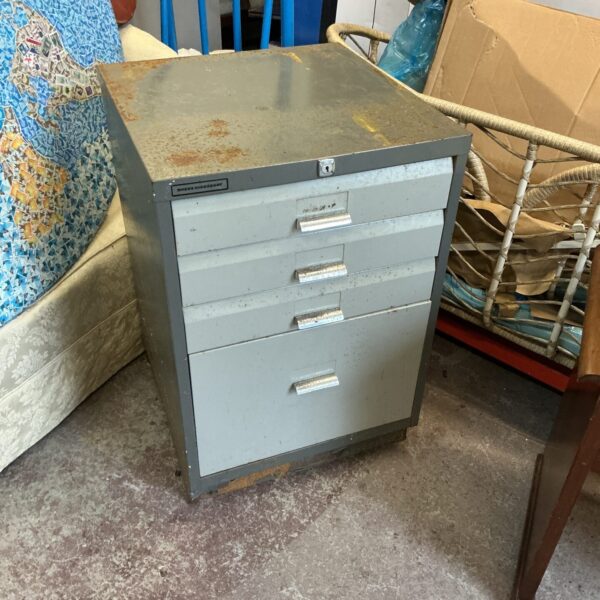 Vintage metal workshop cabinet with drawers for tool storage.