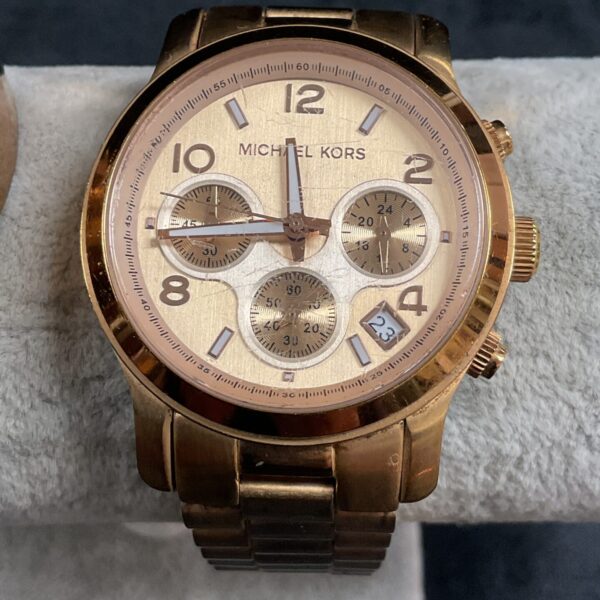 Gold Michael Kors wristwatch with chronograph dials.