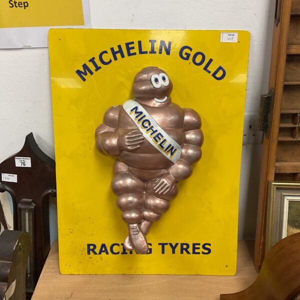 Vintage Michelin Man sign advertising racing tyres.