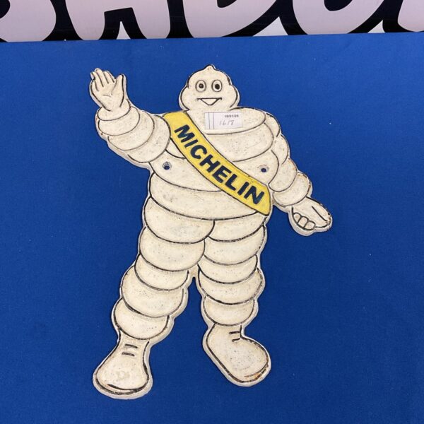 Front view of vintage Michelin Man cast iron wall plaque.