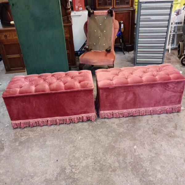 Pair of vintage mid-century pink ottomans with detailed upholstery.