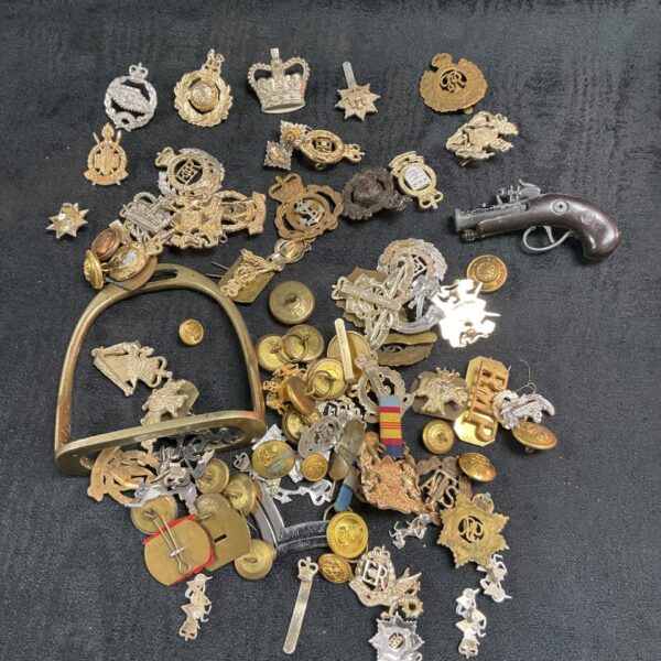 Large collection of vintage military cap badges and insignia.