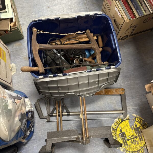 Mitre saw and assorted hand tools in a workshop setting.