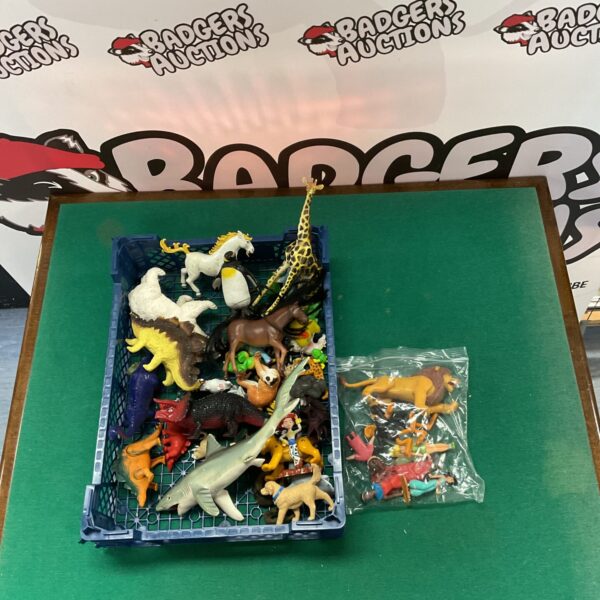 Colourful mixed figure lot with Disney, animal, and dinosaur toys.
