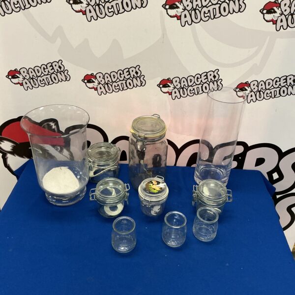 Assorted vintage glassware storage jars for kitchen use.