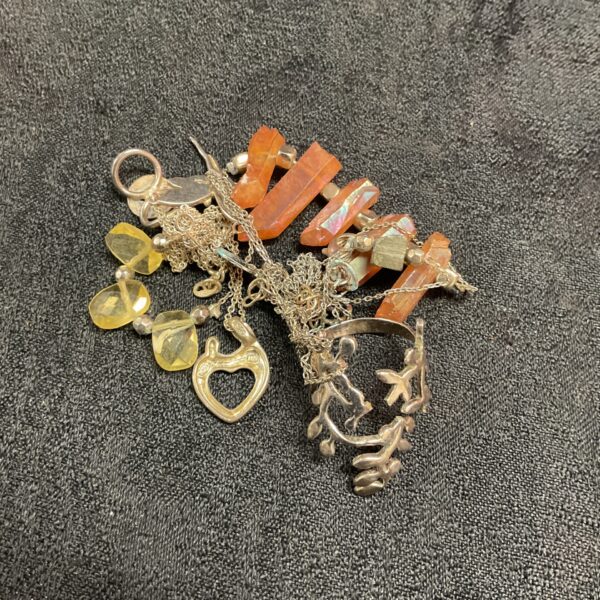 Colourful mixed jewellery lot with silver and beaded necklaces.