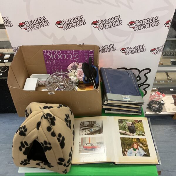 Mixed lot featuring a cat bed and empty photo albums.