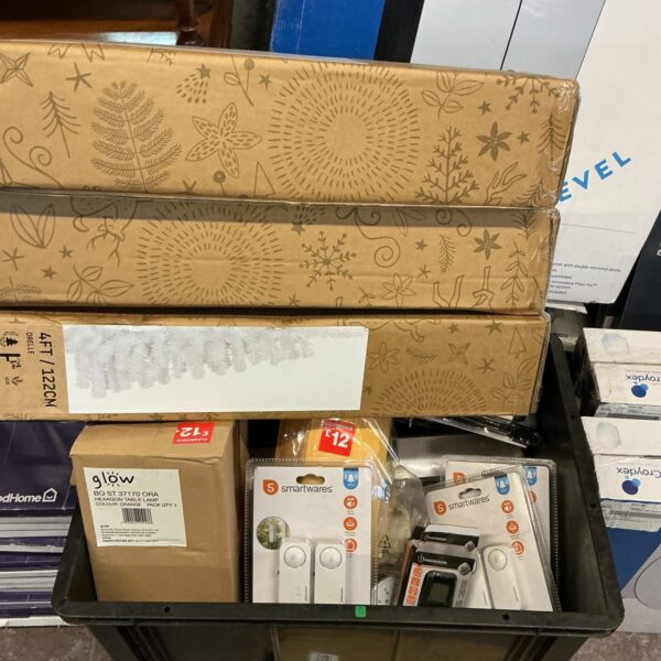 Box of mixed new items including lamps and security devices.