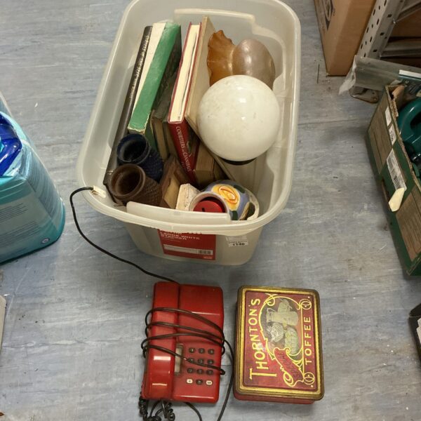 Mixed lot with vintage red telephone and books inside a box.