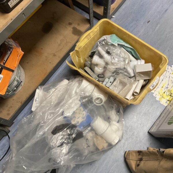 Mixed lot of plumbing and electrical components in a box.