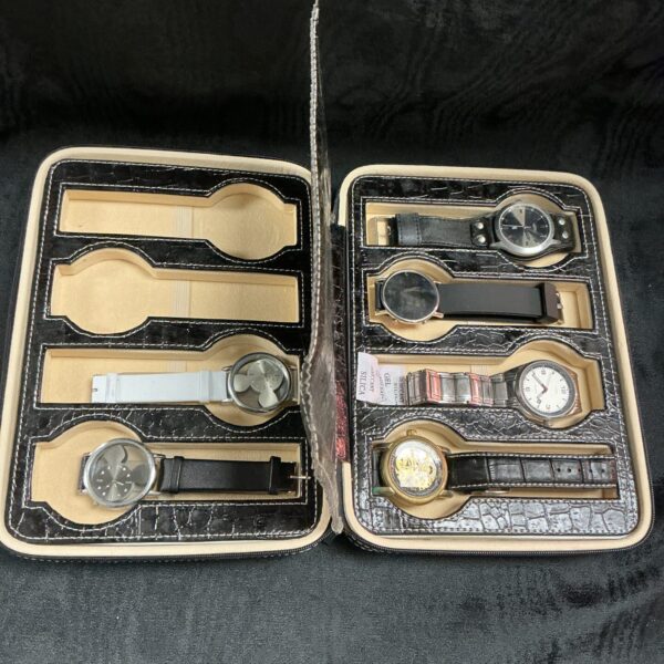 Open case displaying six mixed quartz wristwatches.