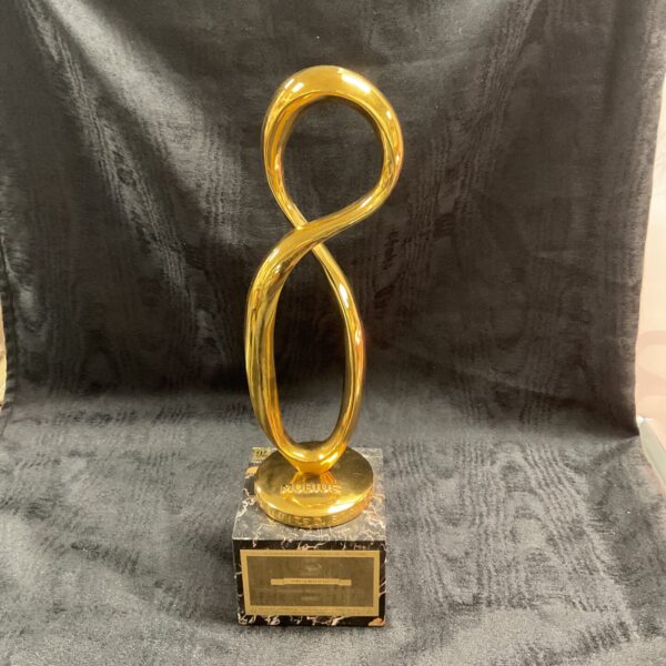 Gold Mobius Award on marble base, vintage advertising collectible.