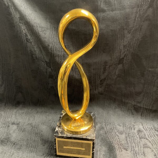 Gold Mobius Award on marble base, vintage advertising collectible.
