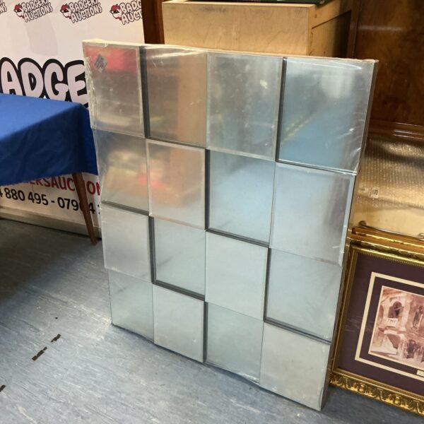 Large modern geometric mirror measuring 49x32 inches.