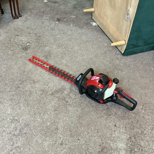 Used Mountfield petrol hedge trimmer for garden maintenance.