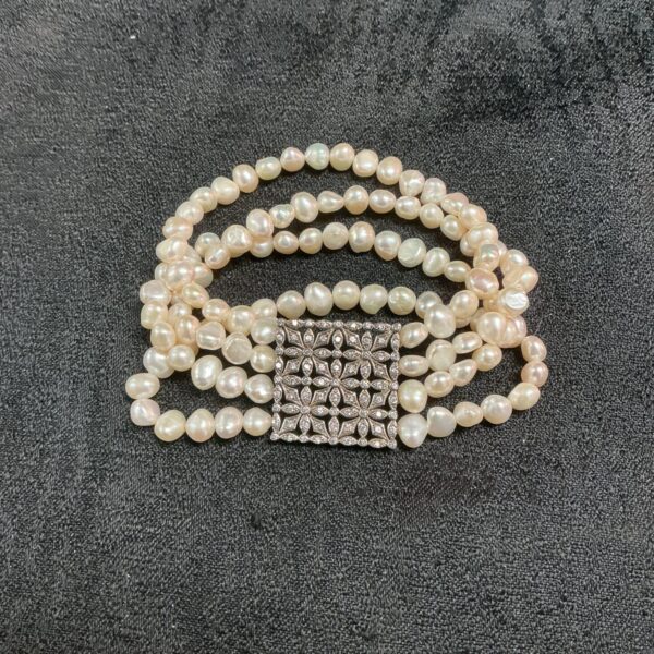 Vintage four strand natural pearl bracelet with silver clasp.