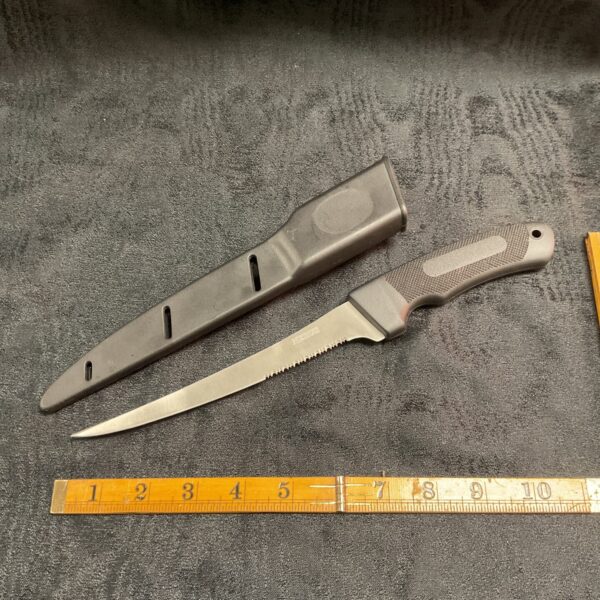 Vintage Nerus fishing knife with black scabbard.