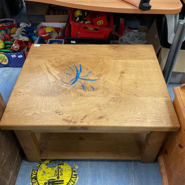 Solid oak coffee table with blue resin detail for living room.
