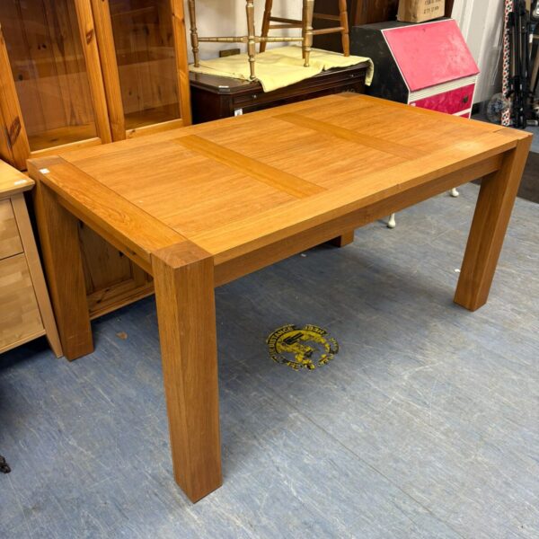 Solid oak farmhouse dining table measuring 59 inches long.