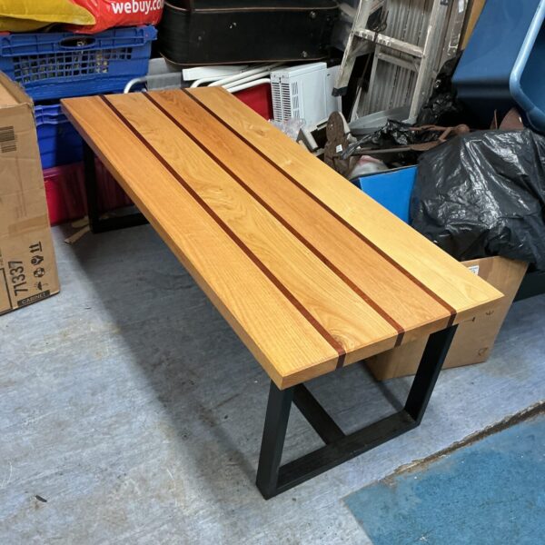 Modern oak coffee table with inlaid wood design.