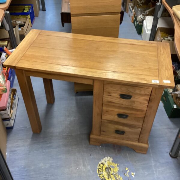 Vintage oak three-drawer desk with spacious storage.