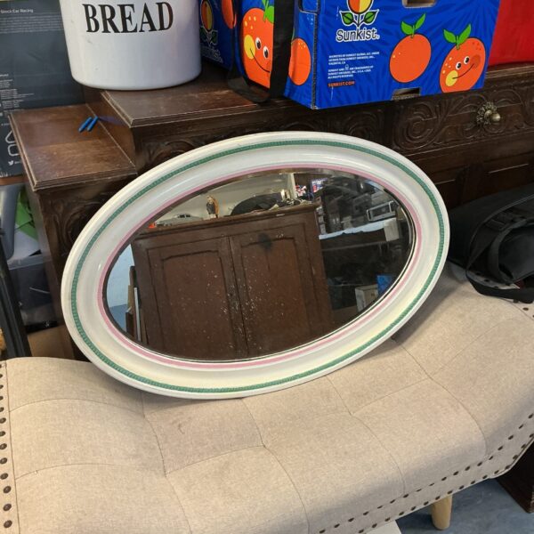 Vintage oval framed mirror for wall decor.