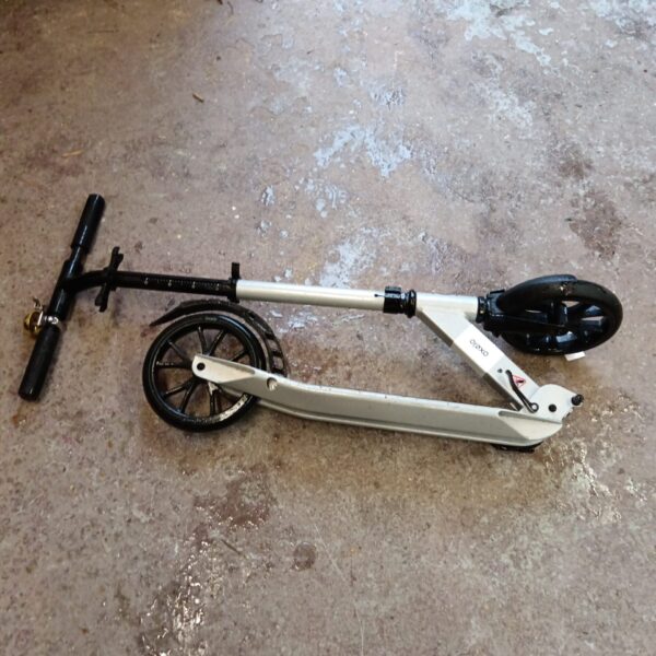 Silver Oxelo folding scooter in a side view.